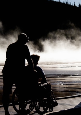 man and woman kissing on beach during daytime