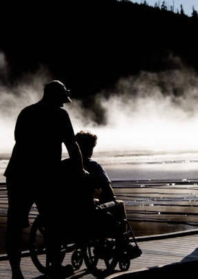 man and woman kissing on beach during daytime