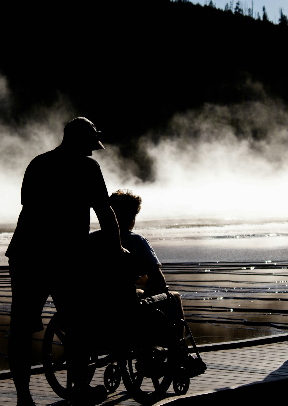 man and woman kissing on beach during daytime