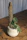 Close-up of a stylish polyethylene plant support holding a vibrant green plant.
