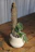 Close-up of a stylish polyethylene plant support holding a vibrant green plant.