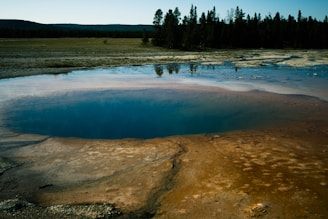 A serene view of therapeutic hot water springs surrounded by natural Egyptian landscape.