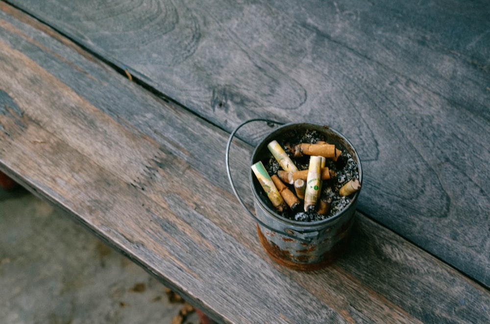 cigarette butts in round black ashtray