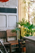 A cozy corner with wooden chairs and potted plants, perfect for intimate gatherings.