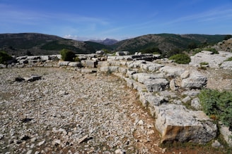 A serene desert landscape with ancient stone ruins under a clear blue sky