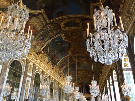 white and gold uplight chandelier in Palace of Versailles France
