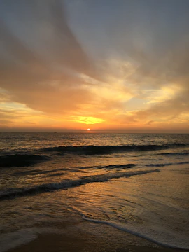 Album cover art showing a sunrise over a calm sea with warm tones