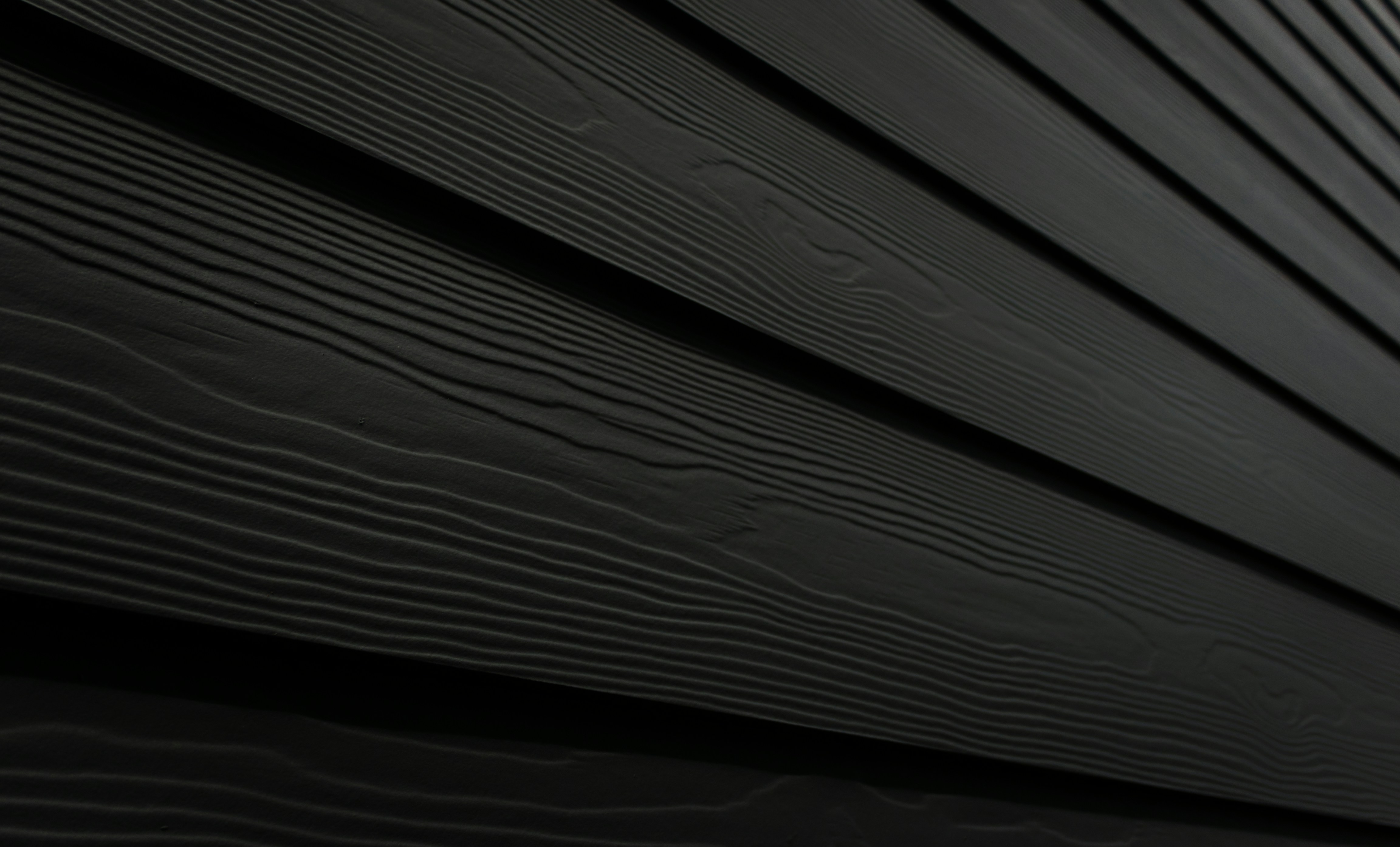 Close-up of gray aluminum siding on home, bright afternoon light, clean lines