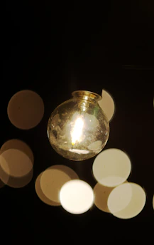 A glowing light bulb surrounded by smaller lights representing shared ideas.