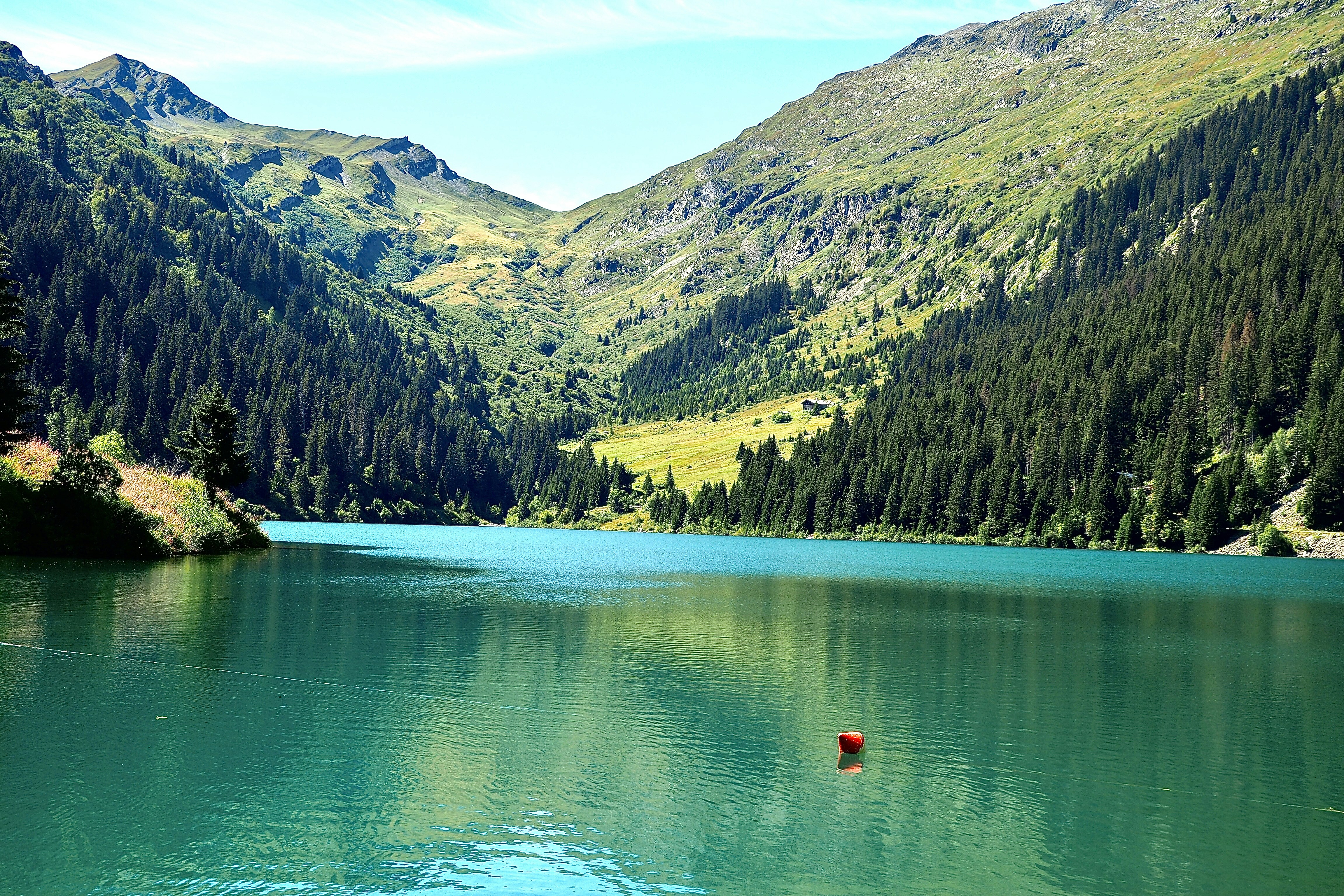 Grüner See tagsüber von Bergen umgeben