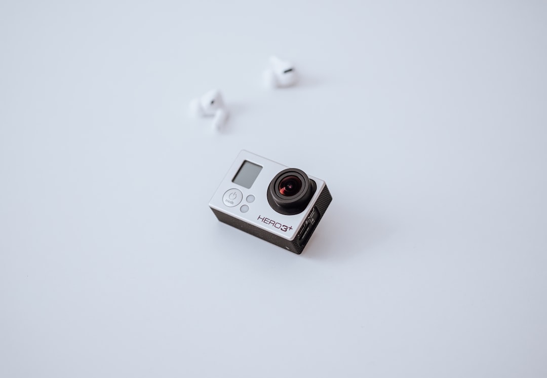 white and black camera on white surface
