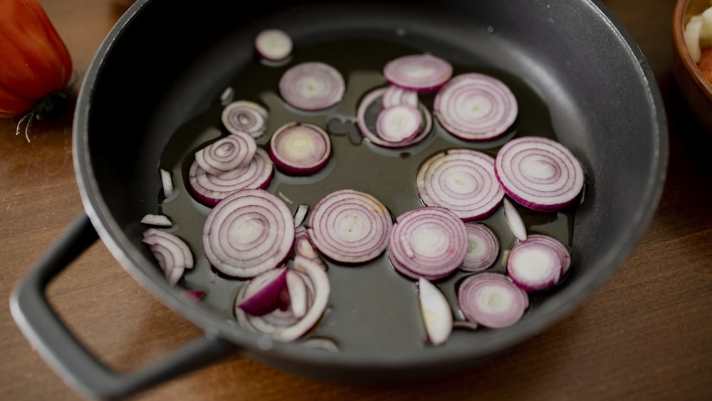 pink and white round candies on black round plate