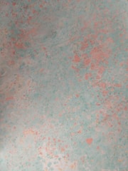 Soft pastel blue pigment powder gently spread on a textured background.