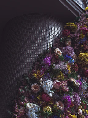 A vibrant flower wall backdrop with soft natural lighting, perfect for events in Dubuque.