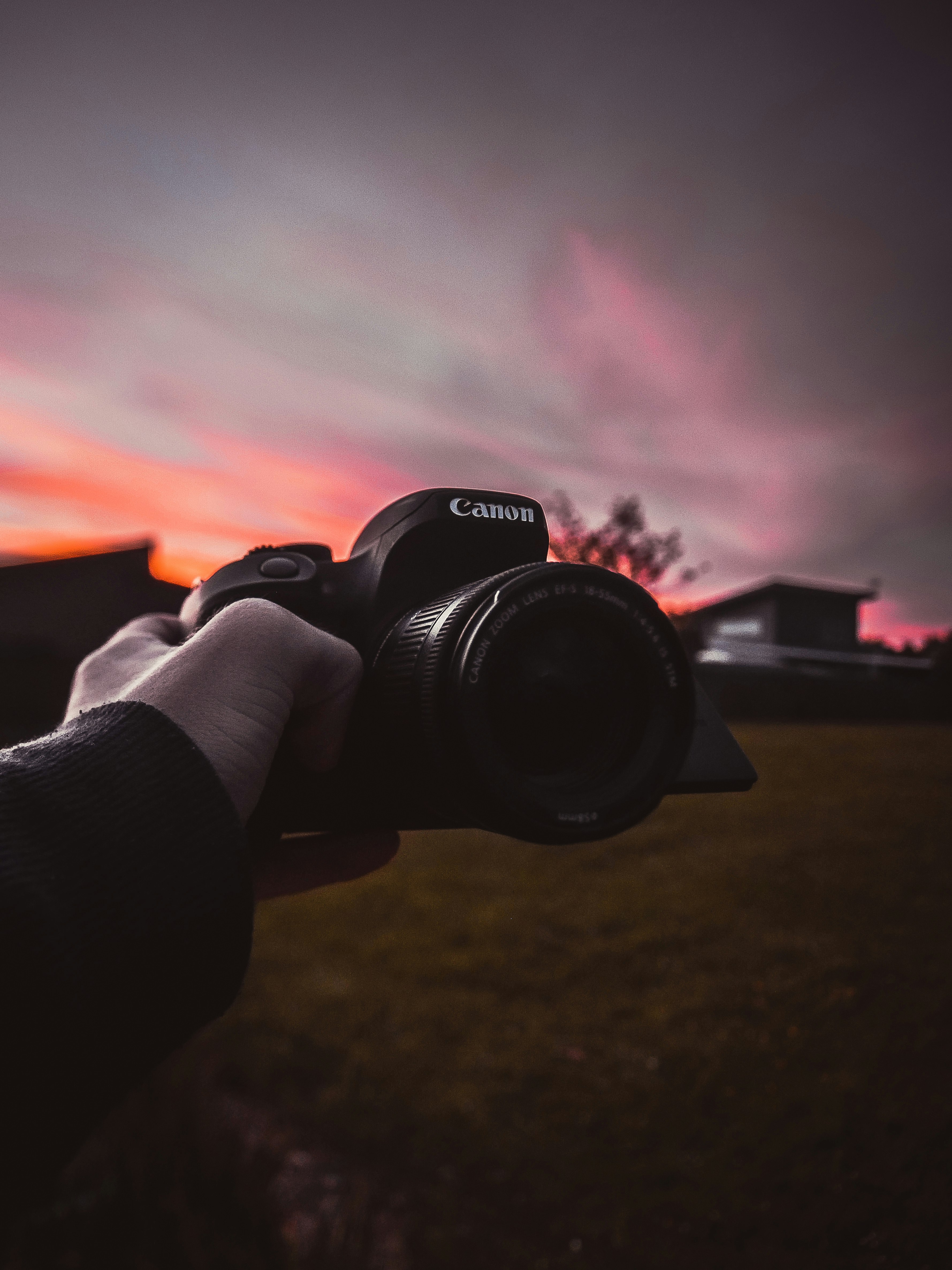 person holding black nikon dslr camera