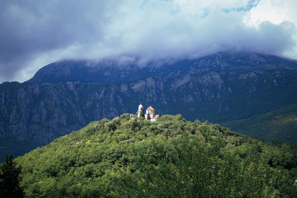 person sitting on top of mountain during daytime