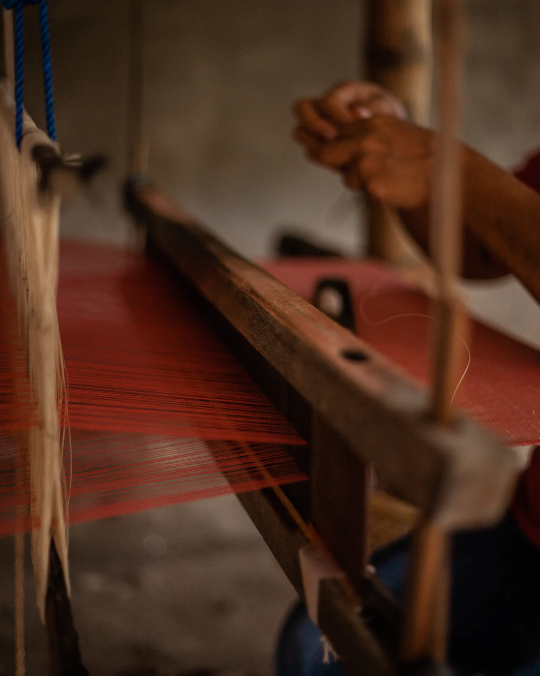 A traditional wooden loom strung with wool