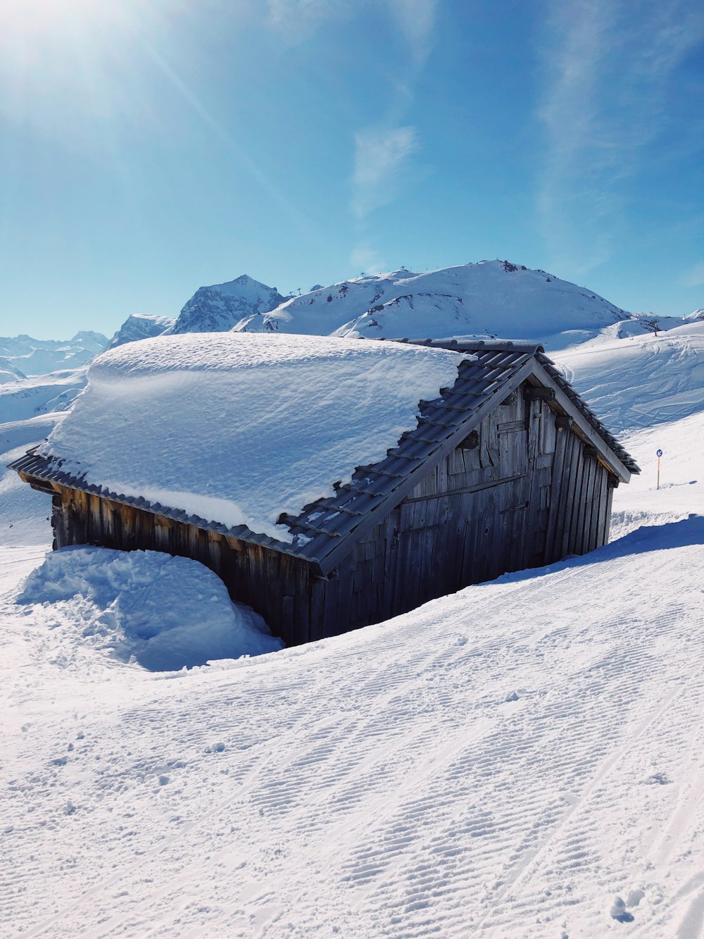 brown wooden house on snow covered ground