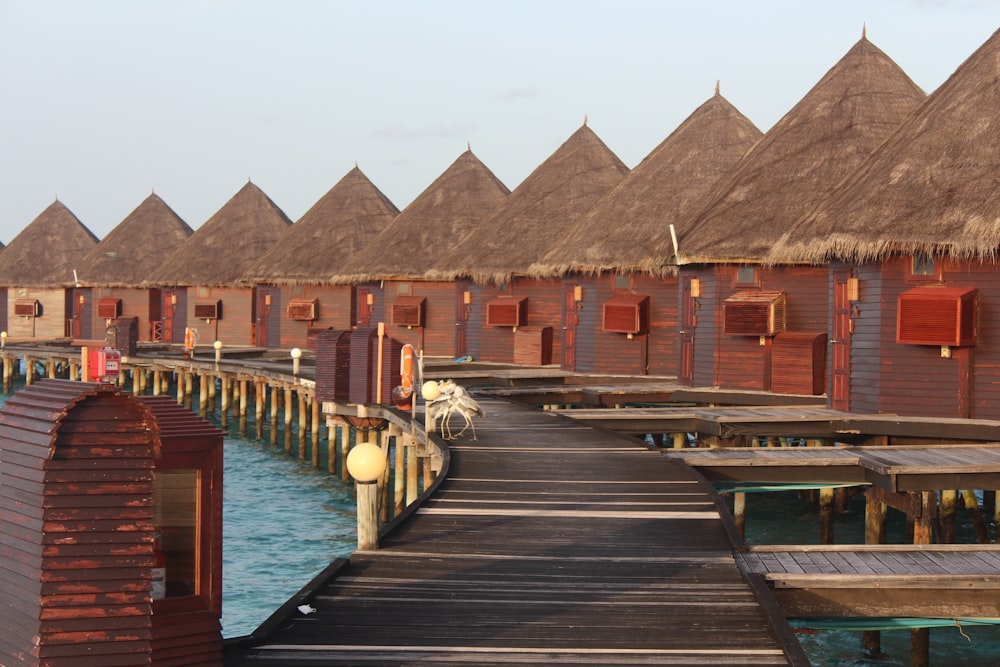 brown wooden house on dock during daytime