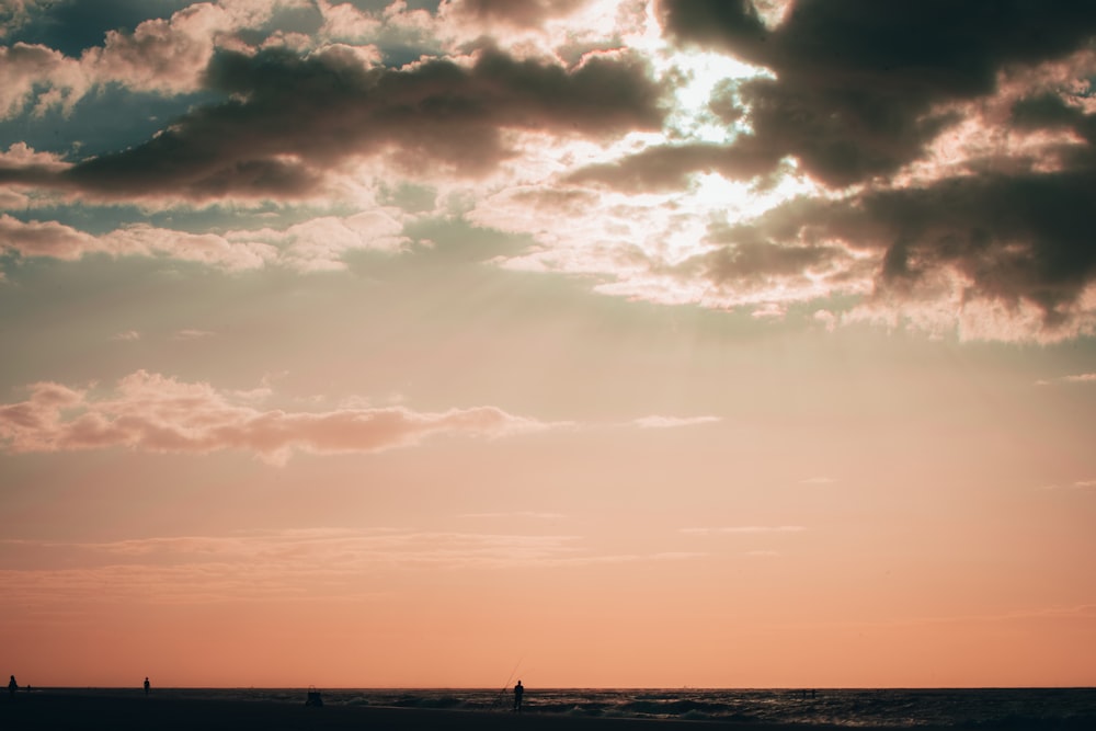 silhouette of people on beach during sunset