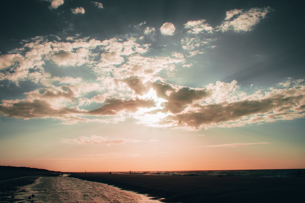 silhouette of people on beach during sunset