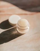 white round plastic container on brown paper