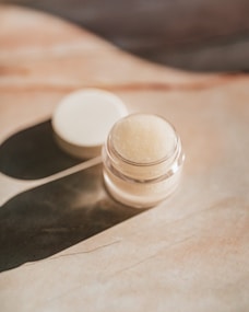 white round plastic container on brown paper