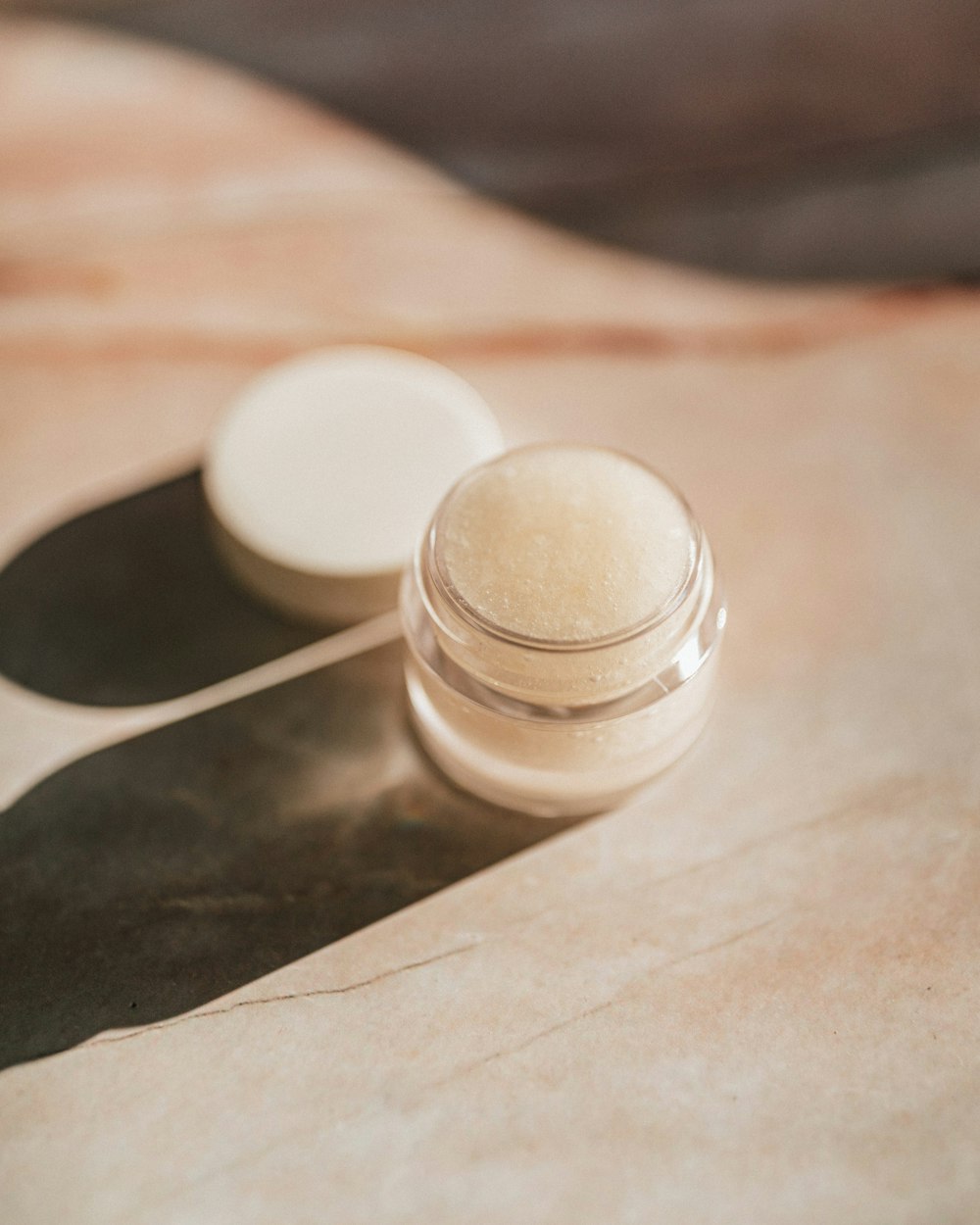 white round plastic container on brown paper