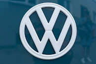 silver mercedes benz emblem on blue surface