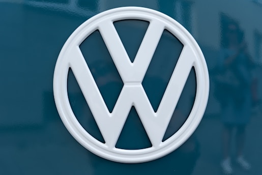 silver mercedes benz emblem on blue surface