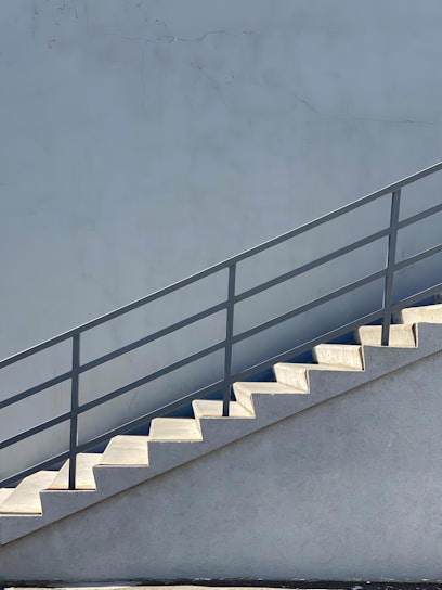 white concrete staircase with black metal railings