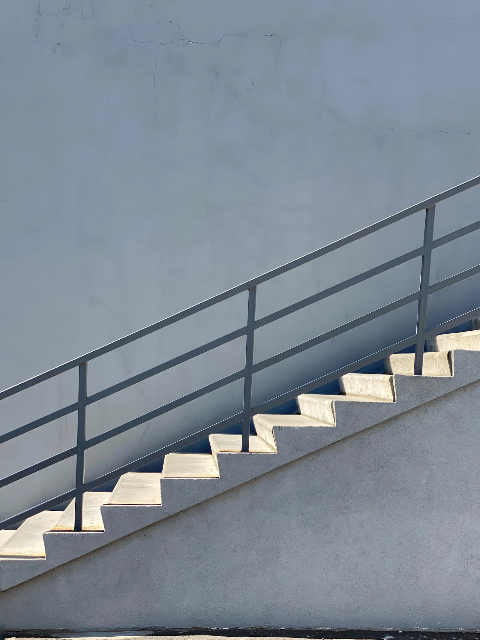 White concrete staircase with black metal railings