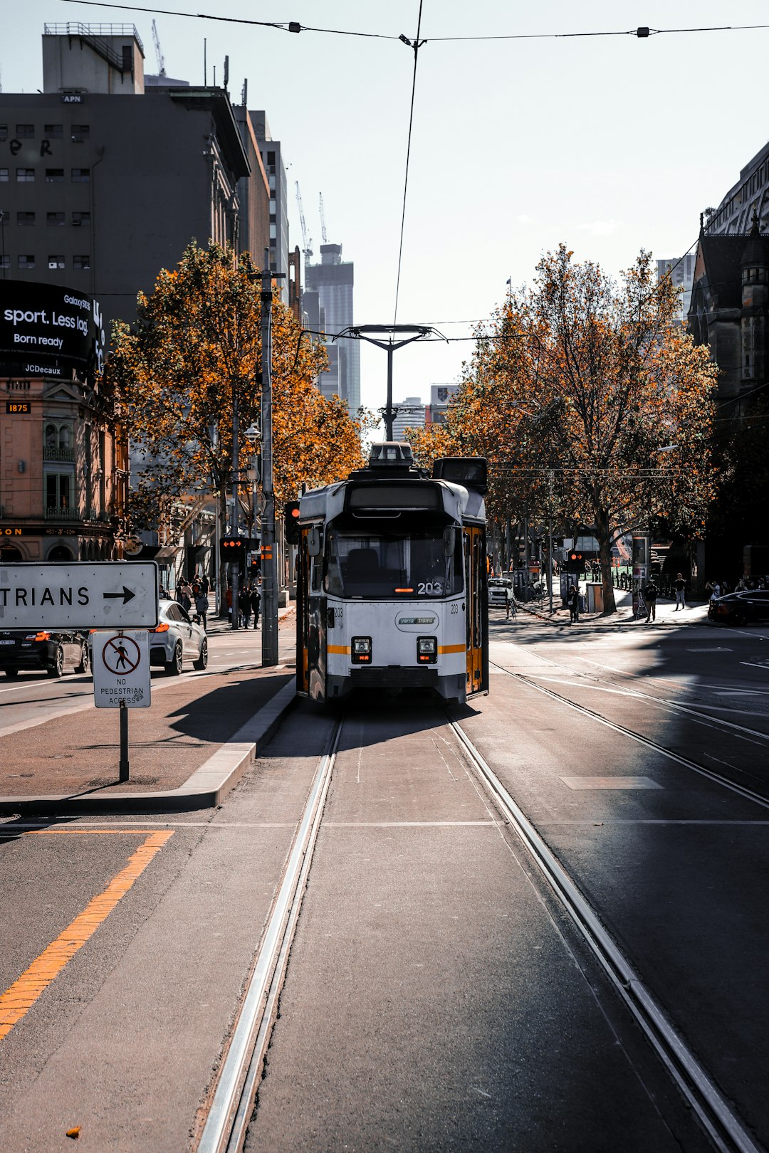 yellow and white bus on road during daytime