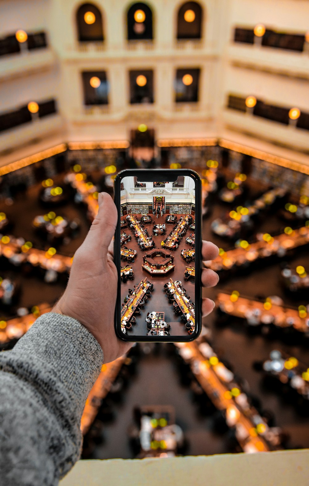 Persona sosteniendo una funda de iPhone negra y dorada