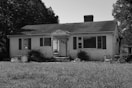 grayscale photo of 2 storey house