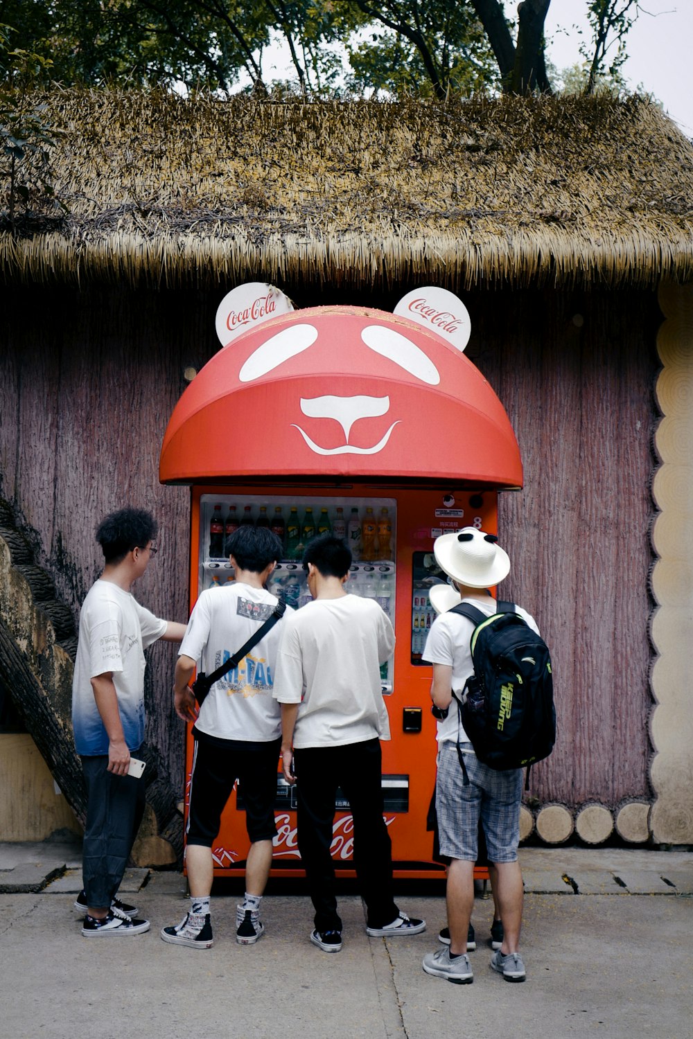 3 men in white shirt and black pants standing near red and white chinese lantern