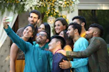 Group selfie in front of 90s-themed decorations with bright neon colors and smiley faces.