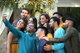 A group of people smiling and posing during a festive event.