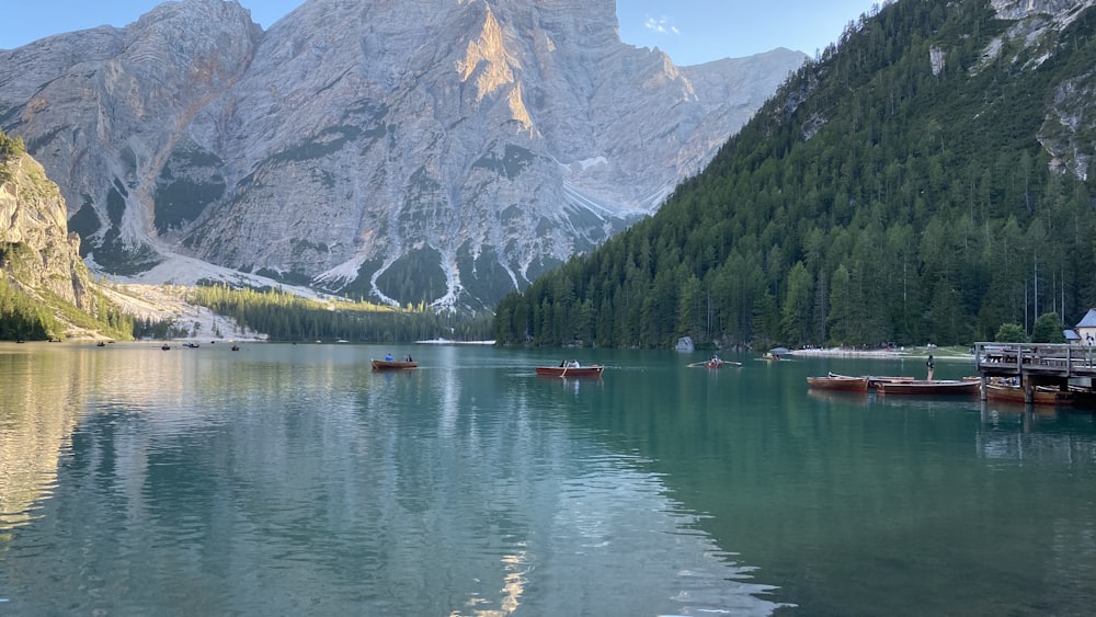 boat on lake near mountain during daytime