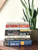 stack of books on white table