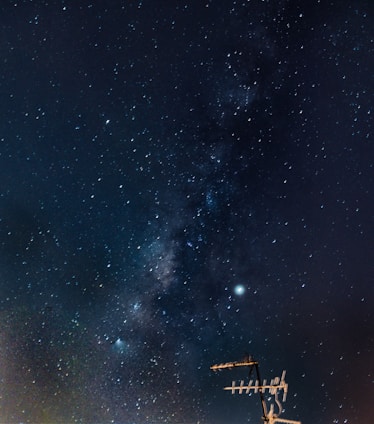 Illustration of xposat satellite orbiting Earth with a starry background.