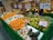 A satisfied shopper browsing through fresh fruits at Vindhya Bazaar.