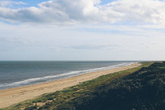 body of water under white clouds during daytime in Wexford Ireland