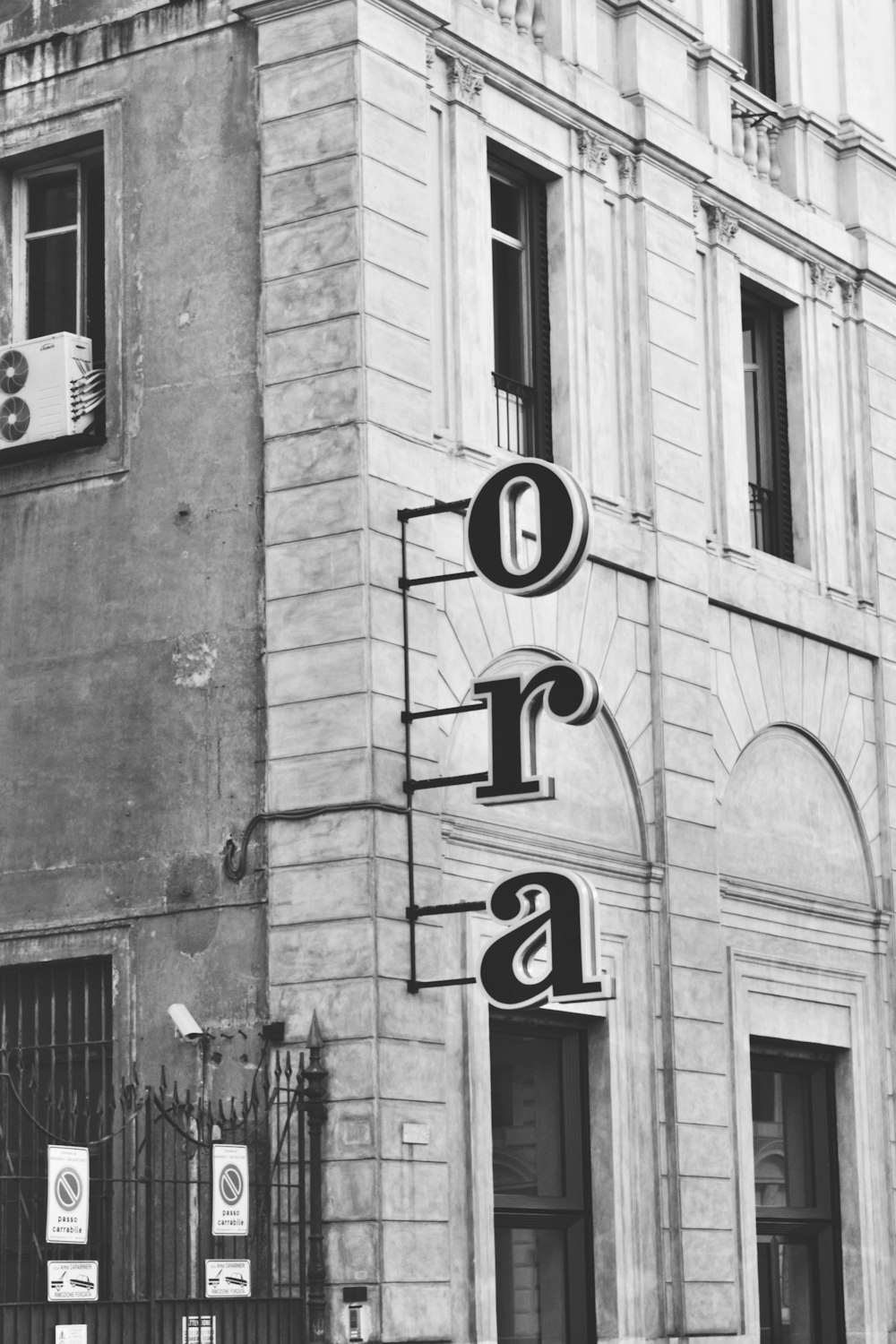 grayscale photo of love sign on building
