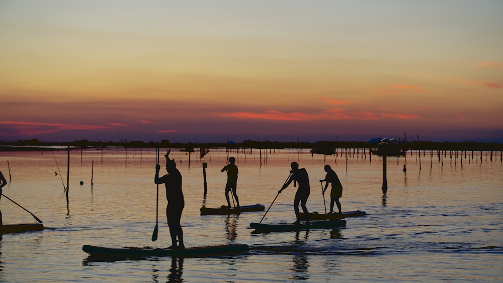 silhouette of people on boat during sunset