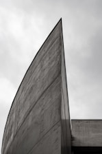 gray concrete building under white clouds during daytime