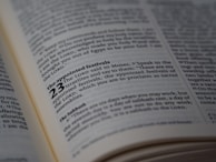 A close-up view of a page from a book, likely a Bible, highlighting the text about 'The appointed festivals' in Leviticus 23. The page is open and well-lit, with the text clearly in focus, showing detailed scripture.