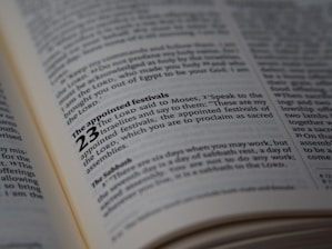 A close-up view of a page from a book, likely a Bible, highlighting the text about 'The appointed festivals' in Leviticus 23. The page is open and well-lit, with the text clearly in focus, showing detailed scripture.