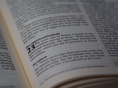 A close-up view of a page from a book, likely a Bible, highlighting the text about 'The appointed festivals' in Leviticus 23. The page is open and well-lit, with the text clearly in focus, showing detailed scripture.
