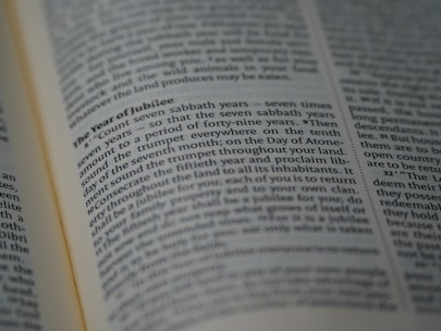 A close-up of an open book displaying a section titled 'The Year of Jubilee', with clear, focused text in the middle surrounded by other text in slightly blurred view.
